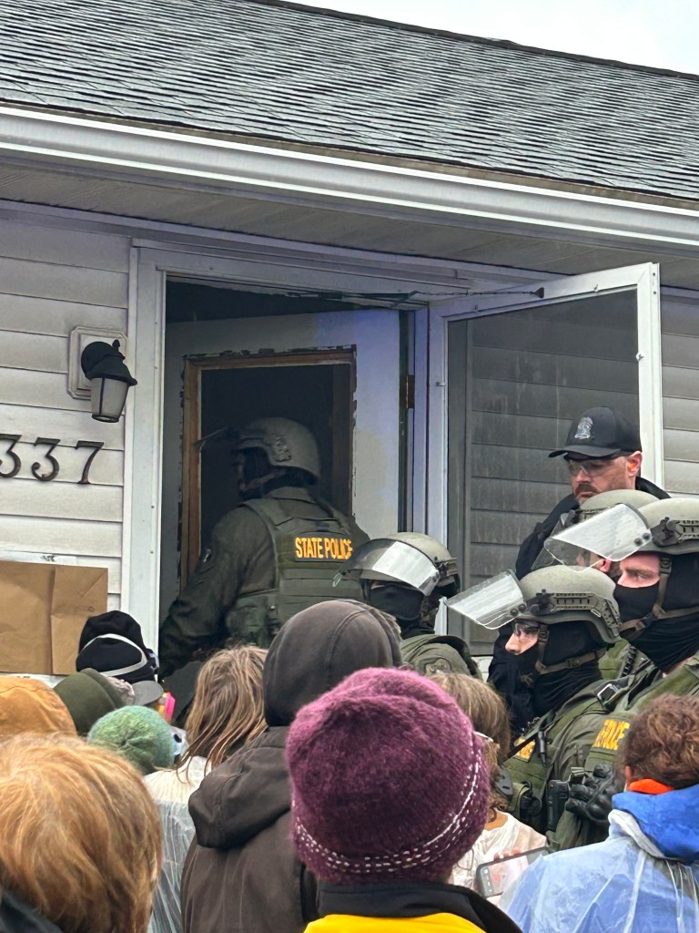 A State police officer enters the house